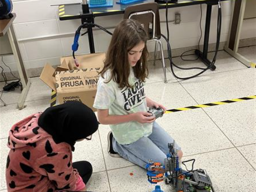 Students driving a robot.